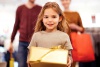 Child holding gift for her parents