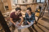 A couple looking at blue prints