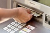 Hand using an ATM