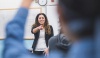 Teacher pointing to a studen that has their hand up