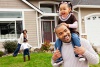 family playing outside in front lawn