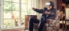 Senior wearing VR headset on lounge chair.