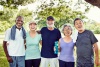 A group of seniors enjoying each others company in the park after an aerobics exercise session.