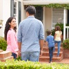 Parents and kids entering home.