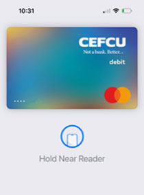 view of debit card in use on a digital pad, text on screen says hold near reader
