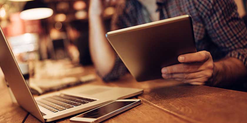 Man in cafe using tablet.